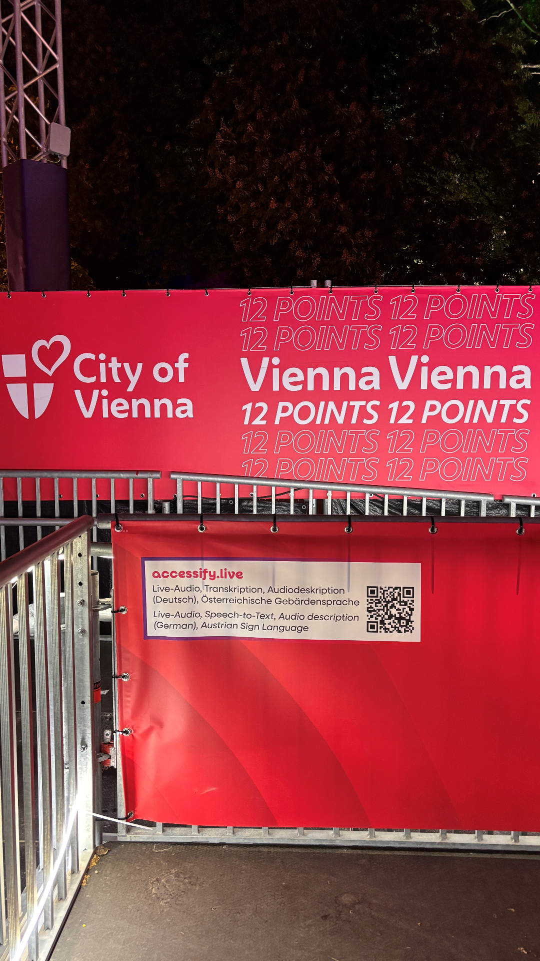 Accessify QR code banner mounted on the wheelchair platform at Eurovision Village on Rathausplatz, Vienna
